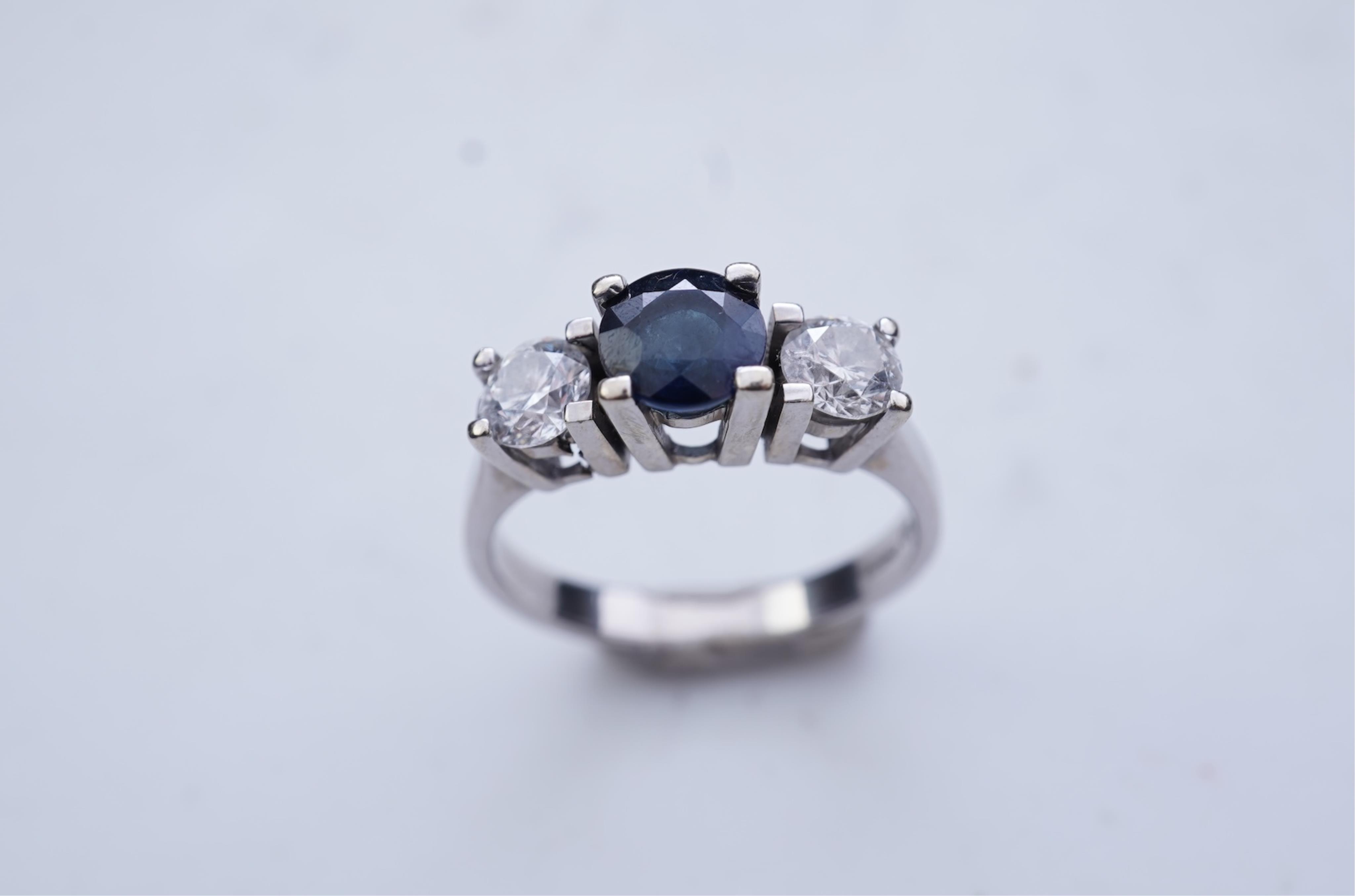 A sapphire and diamond three-stone ring